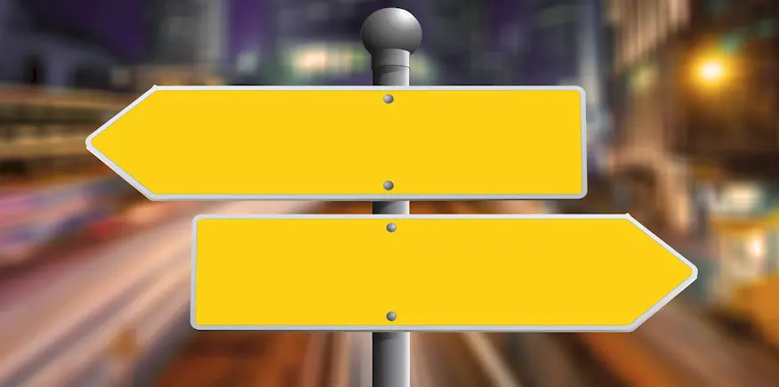 Richtungsschilder als Symbolbild: AEVO-OnlineKurs oder Präsenzseminar?